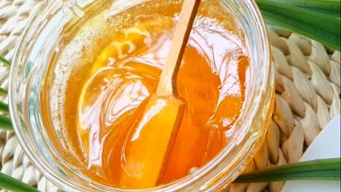 Slow motion of mixing sugaring paste in a glass container. Stock Footage 133511996