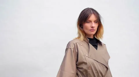 Slow motion of a model with coat posing during a photo session Stockbeeldmateriaal 59738169