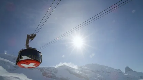 Slow motion of modern cabin of cable railway with Swiss flag decor on bottom Stock Footage 129092840