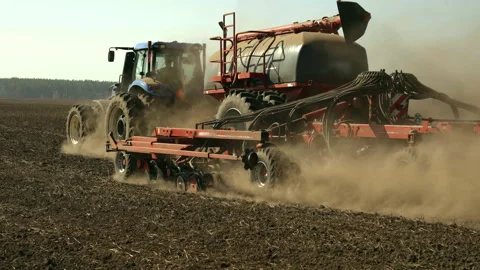 Slow motion Modern Tractor Towing Precision Air Seeder Sowing Crops Stock Footage 305262226