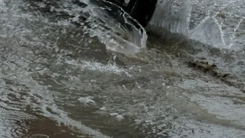 The slow motion of the motorbike passing through a puddle creates splashes o Stock Footage 291556953