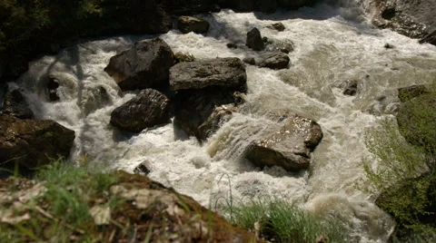 Slow motion of mountain river crashing down on rocks. Tracking shot Видео 65216062