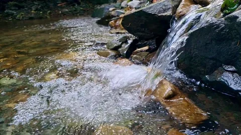 Slow motion of mountain river flowing over rocks Stock Footage 160888538