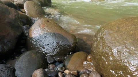 Slow motion of mountain river flowing over rocks 動画素材 307440105