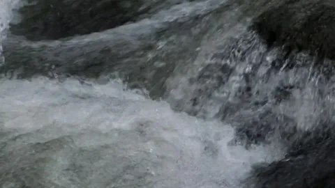 Slow motion of mountain river water passing through a rocky cascade Stock Footage 297716474