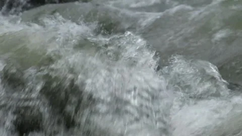 Slow motion of mountain river water passing through a rocky cascade Video stock 297716483