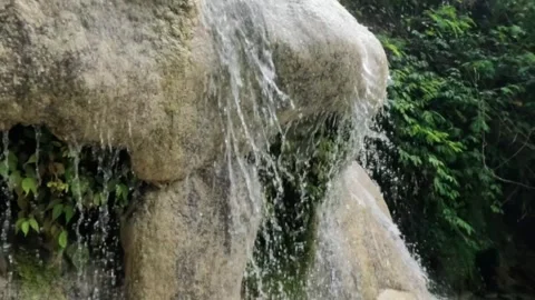 Slow motion of a mountain waterfall passing through limestone rocks Video stock 321322128