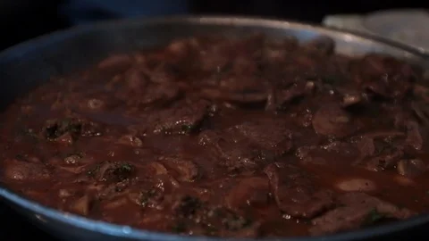 Slow motion move away flank steak bubbling in sauces Stock Footage 106052759