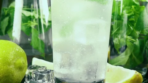 Slow motion movement of bubbles in a misted glass in water and ice cubes and Stock Footage 92207945