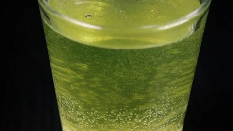 Slow motion movement of the camera on an effervescent tablet Stock Footage 87878712