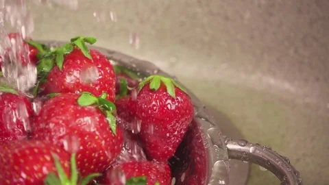 Slow motion movement of the camera sideways and downwards on a strawberry under Stock Footage 90258024