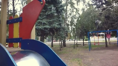 Slow motion, Moving the camera. Children run around the playground. Video stock 79535208