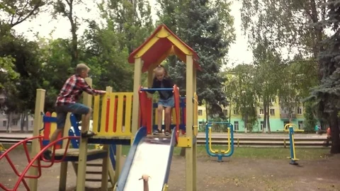 Slow motion, Moving the camera. Children play on the playground Video stock 79585602