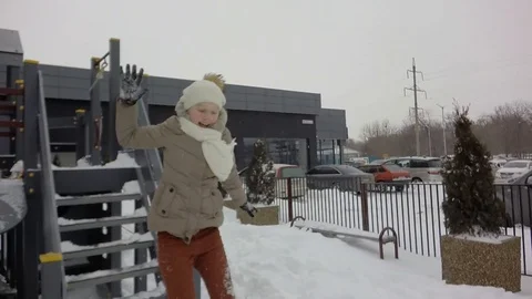 Slow motion, Moving the camera. Children are jumping into the snow. Snowing. Video stock 87544664