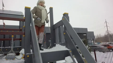Slow motion, Moving the camera. Children are jumping into the snow. Snowing. Stock Footage 87544851