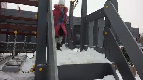 Slow motion, Moving the camera. Children are jumping into the snow. Snowing. Stock Footage 87544874