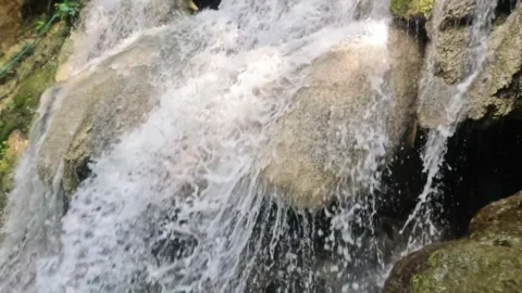 Slow motion moving camera of a clear waterfall in the mountains Video stock 321861423