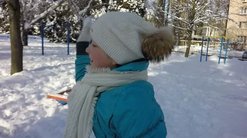 Slow motion, Moving the camera. Funny children throw snow at each other. Video stock 87543706