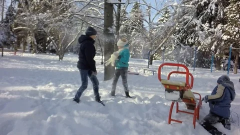 Slow motion, Moving the camera. Funny children throw snow at each other. Video stock 88242997