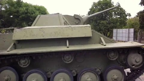 Slow motion, Moving the camera. The girl is inspecting a military tank. Video stock 79468652