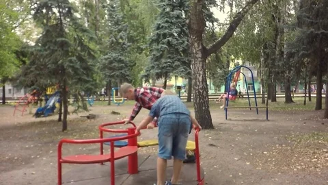 Slow motion, Moving the camera. Happy kids ride on the carousel. Video stock 79753706