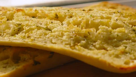 Slow Motion Moving Over Freshly Baked Artisanal Garlic Herby Ciabatta Bread on Stock Footage 336616648