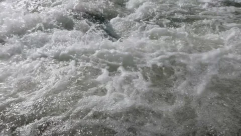 Slow motion moving shot above a clear rocky mountain river Stock Footage 320983022