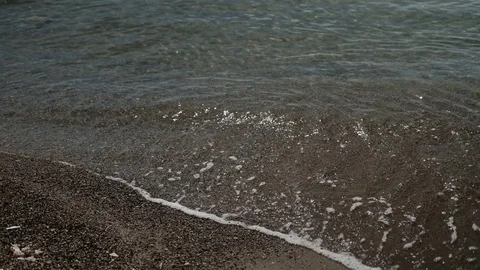 Slow-motion of moving waves on shore of sand outdoors Stock Footage 76630959