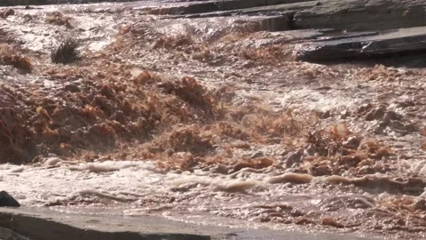 Slow motion of muddy river rapids with water splashing after heavy storm Stock Footage 233913951