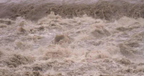 Slow-motion - From muddy stream overflowing its banks to flood rubbles Stock Footage 159305191