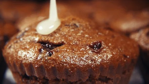 Slow motion muffins pour glaze close up Stock Footage 96170416