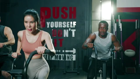 Slow motion of Multi ethnic group of young athletes training on stationary bike Video stock 151605479