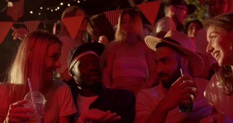 Slow motion multi-ethnic young friends chatting enjoying cocktails at rooftop Stock Footage 115392412
