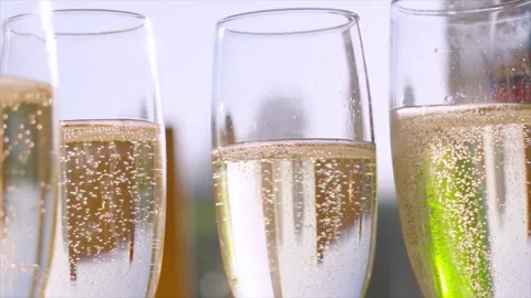 Slow Motion of Multiple Flute Glasses of Champagne with Bubbles Rising in Slow 스톡 동영상 325782327