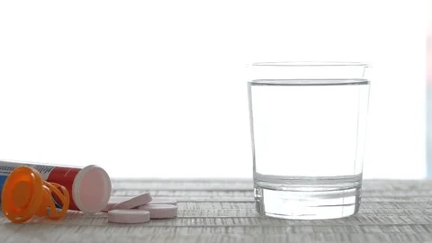 Slow Motion Multivitamin Tablets Concept Falling in Glass of Water Stop Motion Stock Footage 104250018