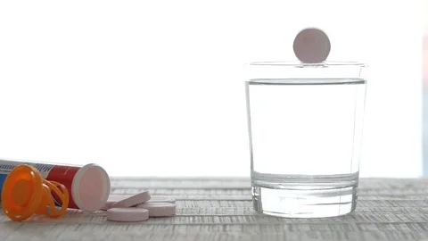 Slow Motion Multivitamin Tablets Concept Falling in Glass of Water Stock Footage 104250155