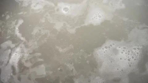 Slow motion murky boiling water Stock Footage 212501332