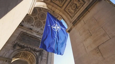 Slow motion NATO flag zoom at Cinquantenaire Arch monument Brussels Belgium Video stock 307999906