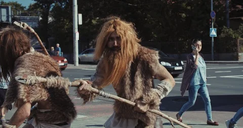 Slow motion neanderthals man of hunter-gatherers in animal fur holding Stock Footage 118396417