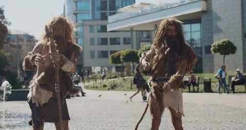Slow motion neanderthals man of hunter-gatherers in animal fur holding Stock Footage 118398094