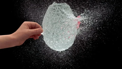 Slow Motion Of Needle Piercing Water Balloon Causing Liquid Splash Stock Footage 314302785