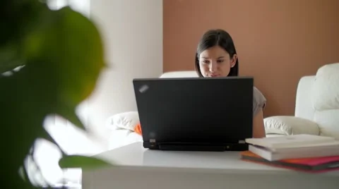 Slow motion of a nice girl browsing laptop at home Video stock 49832159