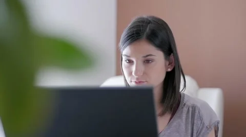 Slow motion of a nice girl browsing laptop at home close up Stock Footage 49833006