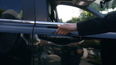 Slow motion of nice womans hand opening black car's door Stock Footage 115490996