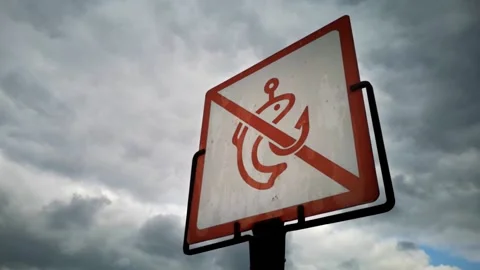 Slow Motion. "No fishing" sign against a cloudy sky. Stock Footage