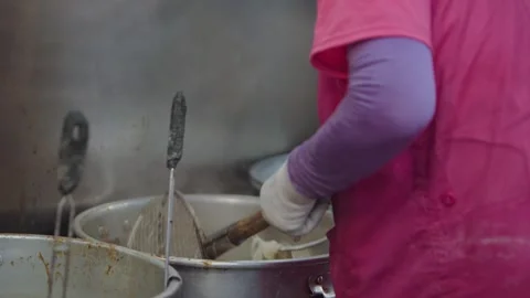 Slow motion of noodle straining with ladle at Korean food stall Stock Footage 313838063