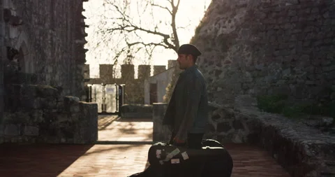 Slow motion of Nuno Santos walking inside Leiria Castle while sun is shining Stock Footage 155264171