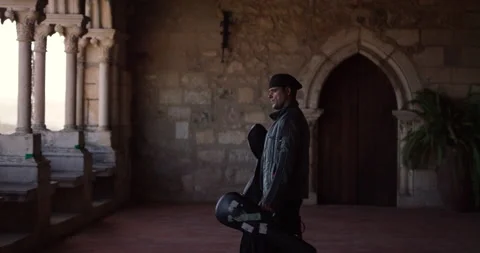 Slow motion of Nuno Santos walking on balcony of Leiria Castle to watch city Stock Footage 155265162