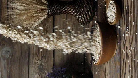 Slow motion of oatmeal falling into a bowl on a wooden table. Stock Footage 259203585