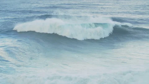Slow motion of ocean water surface lifting up into smaller waves on cloudy day Stock Footage 156083066
